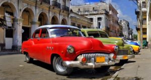 Voyage à Cuba : voitures colorées garées en ville Akaoka